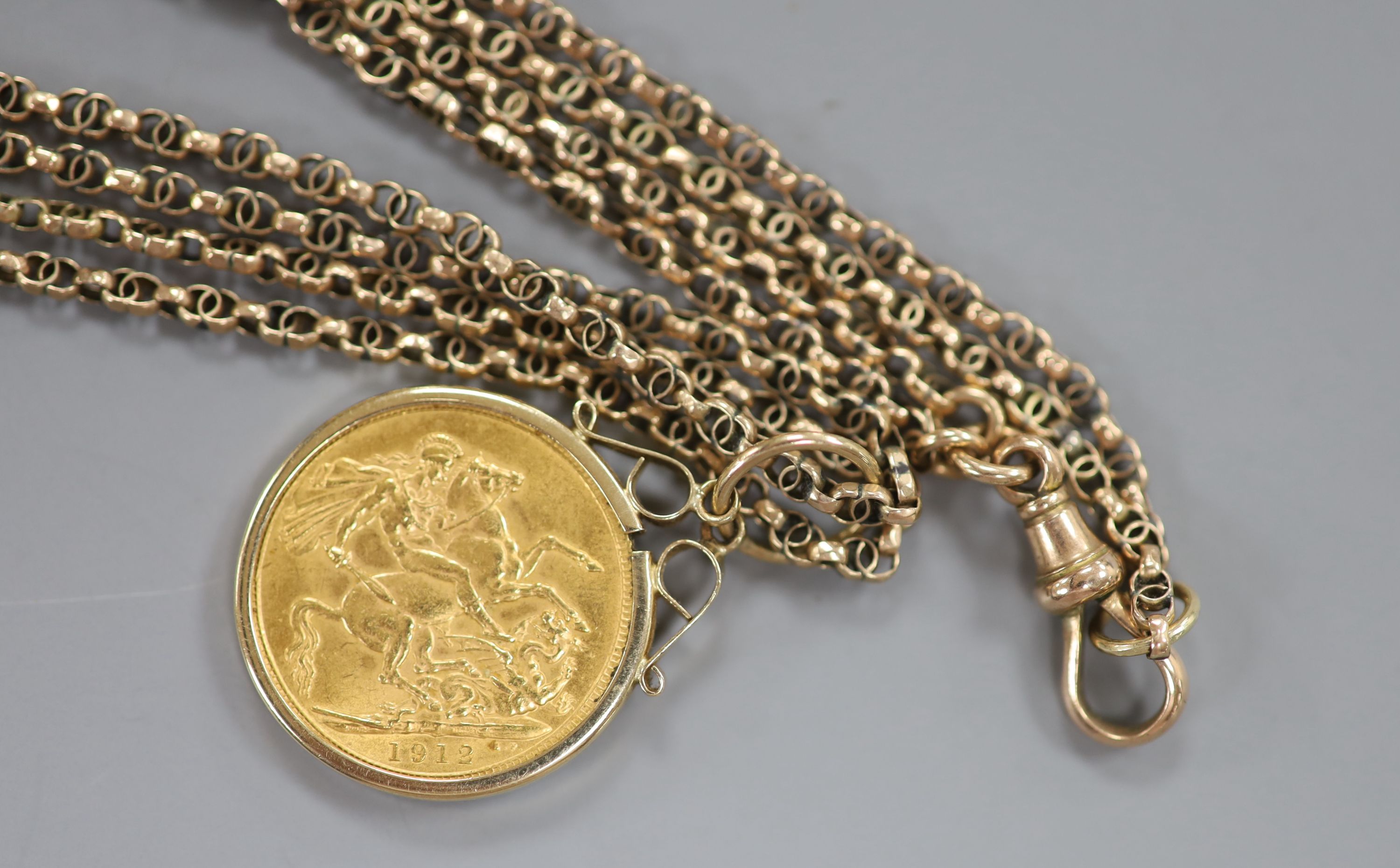 A George V 1912 gold sovereign, in 9ct gold pendant mount, on an Edwardian 9c double link chain, 79cm, gross 26.1 grams.